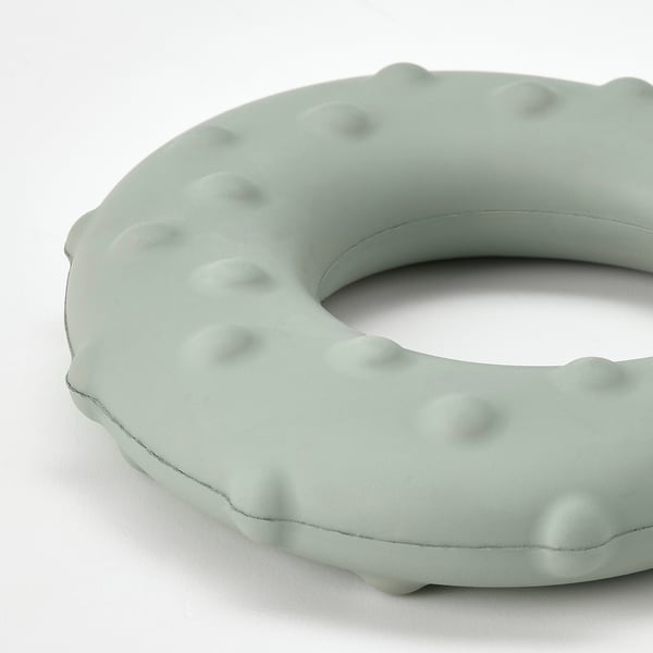Light green interactive dog toy made of durable, textured natural rubber with a hidden treat space.