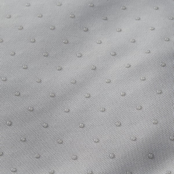 Close-up of durable, textured fabric, likely a pet bed, showing water-resistant properties with droplets on surface.