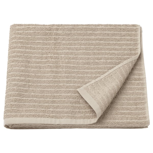 VÅGSJÖN tan towel, folded, terry texture, cotton material.