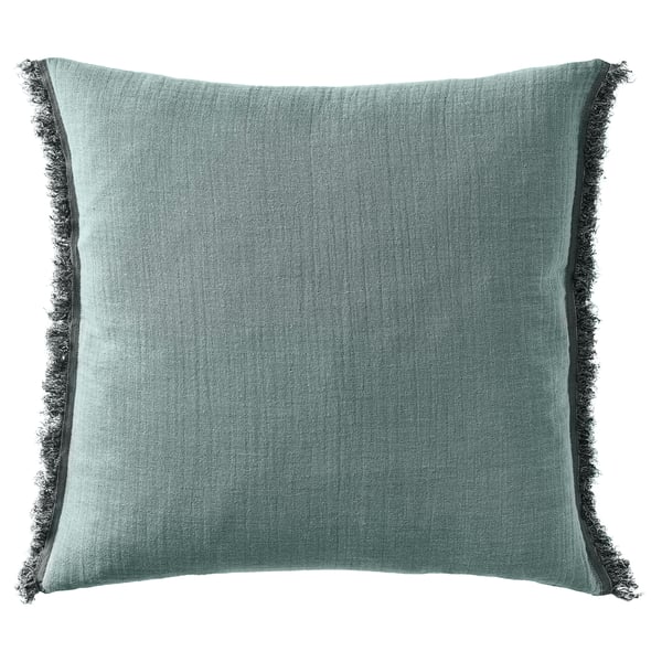 Square throw pillow with teal woven texture and fringed edges.