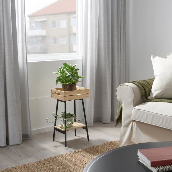 Small VANILJSTÅNG plant stand near window, holding green plant. White curtains, light grey walls.