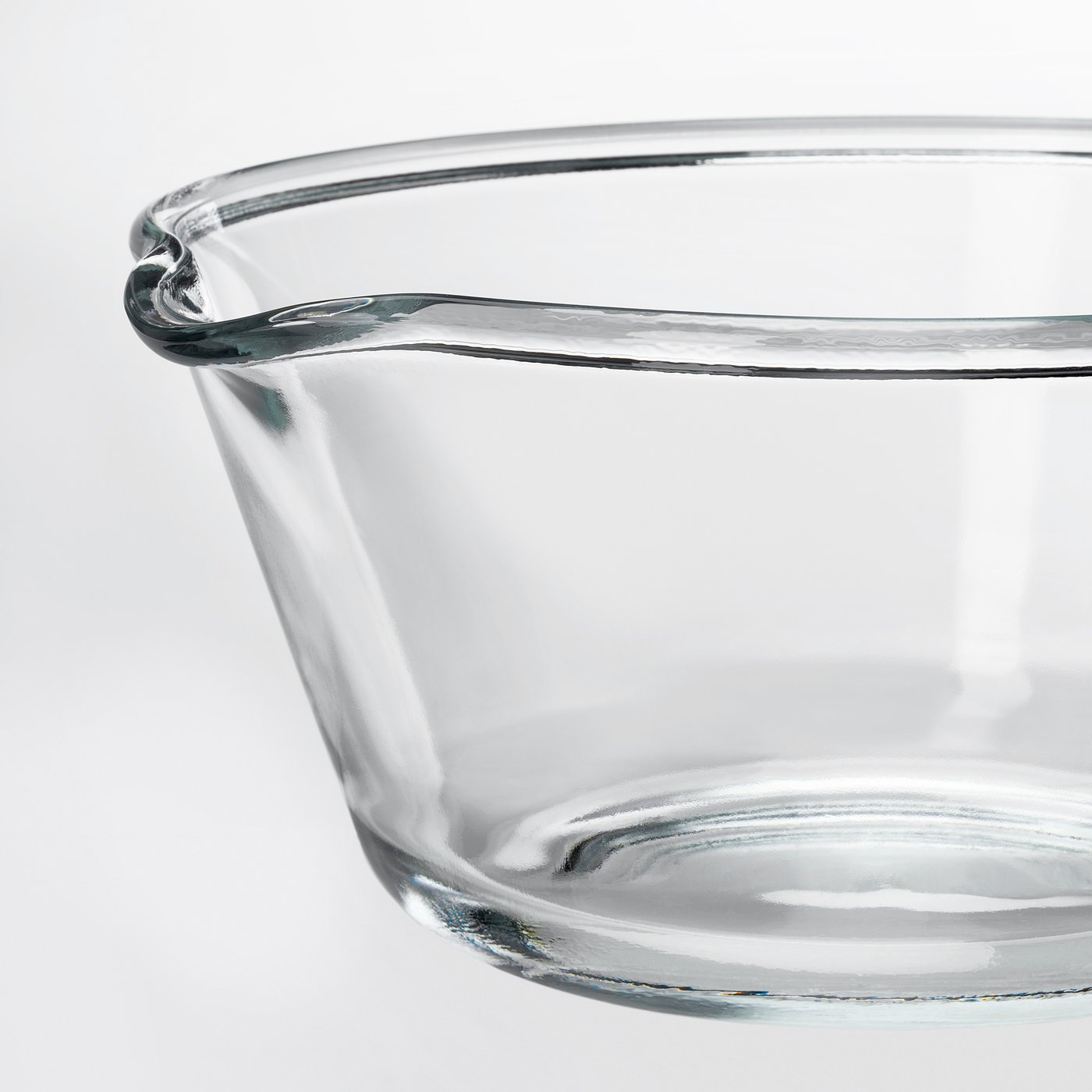 Clear glass bowl with pour spout, showing smooth, well-made edges and transparency.