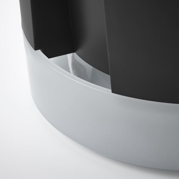 Modern white planter with sleek curves and glossy finish, part of a self-watering system, ensuring plant health.