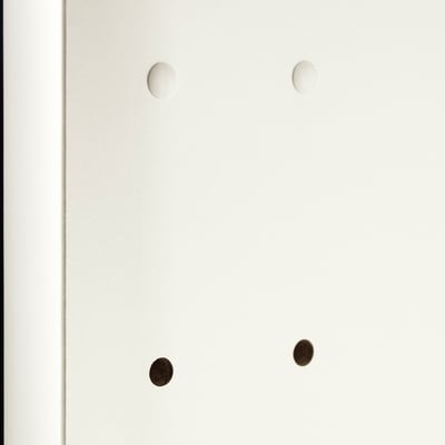 Four circular cover caps, two white, two dark, designed to hide drill holes in cabinetry, ensuring a neat appearance.