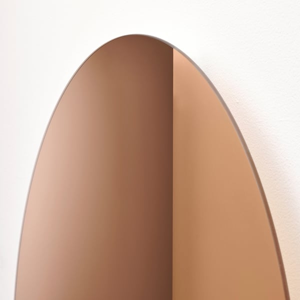 Elegant, arched, golden-toned mirror. High-quality, reflective surface.