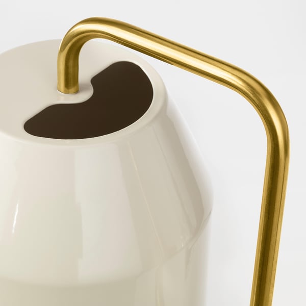 Modern white watering can with gold handle, stylish design for indoor plants.
