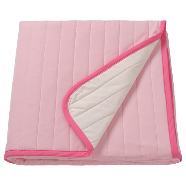 Pink bedspread with white detail, pink edging, rectangular, folded.