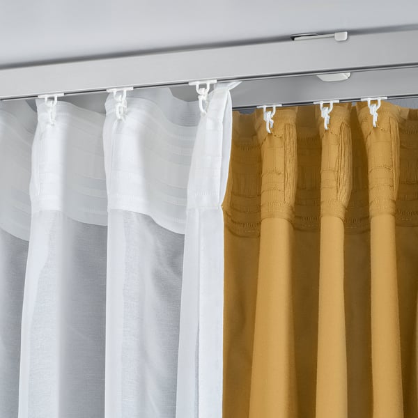 Ceiling-mounted curtains: sheer white for light, opaque beige for privacy; uses VIDGA brackets.
