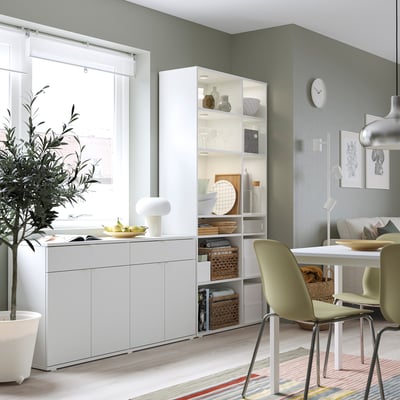 Modern kitchen with white VIHALS storage, green chairs, dining table, and large window.