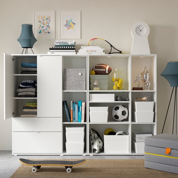 White multi-compartment storage unit, various items displayed, grey wall, modern design.