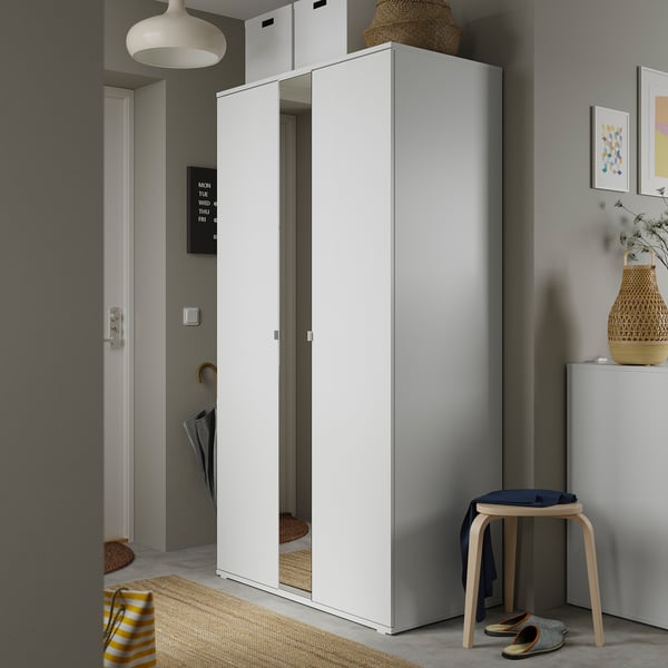 Modern hallway white VIHALS wardrobe with full-length mirror, wooden stool, and decorative accessories.