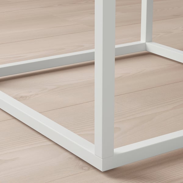 This image shows a close-up of a modern, white metal shelf with smooth edges and clean lines, highlighting its sturdy and contemporary design.