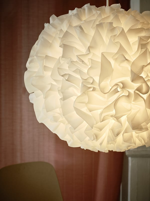 Large hanging light fixture, white, cloud-like design, soft glow.