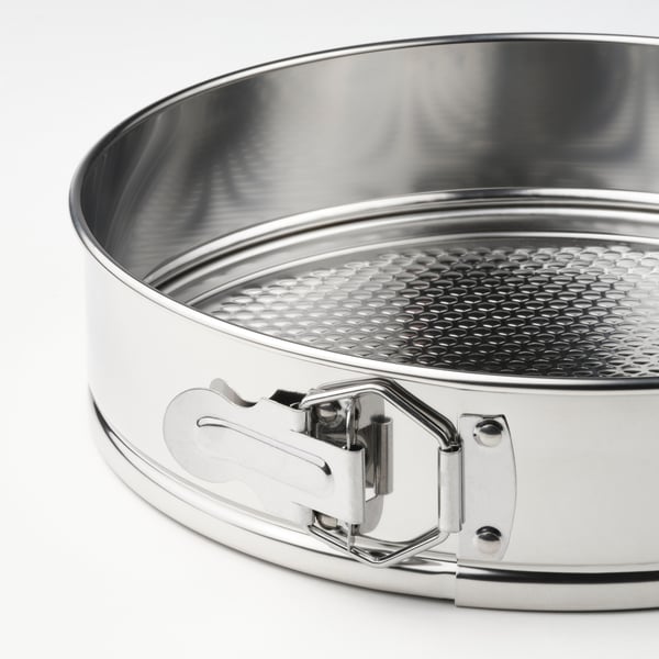 Stainless steel springform pan with secure latch and textured base for even baking.