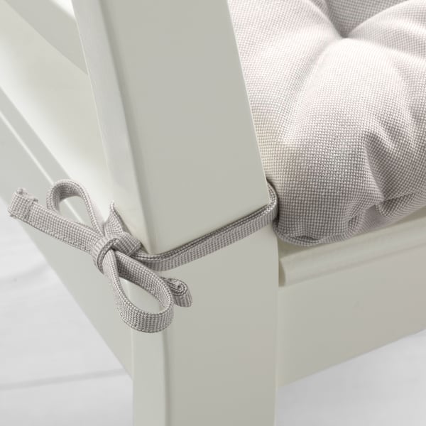 Grey cushioned chair pad with ties for secure fit.