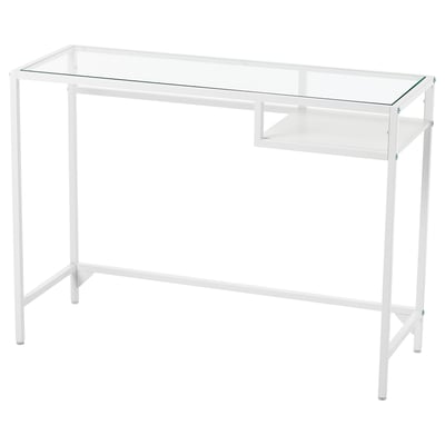 The VITTSJÖ table has a white metal frame, a glass top, and a small glass shelf. Its modern design is sleek and minimalist.