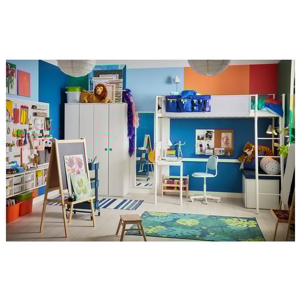 A colourful childs room with a bunk bed, art desk, and storage. Bright walls and organised toys.