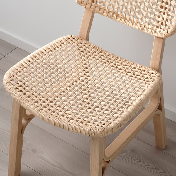 Chair with intricately woven seat and backrest made from natural, sustainable materials. Bamboo frame adds durability and style.