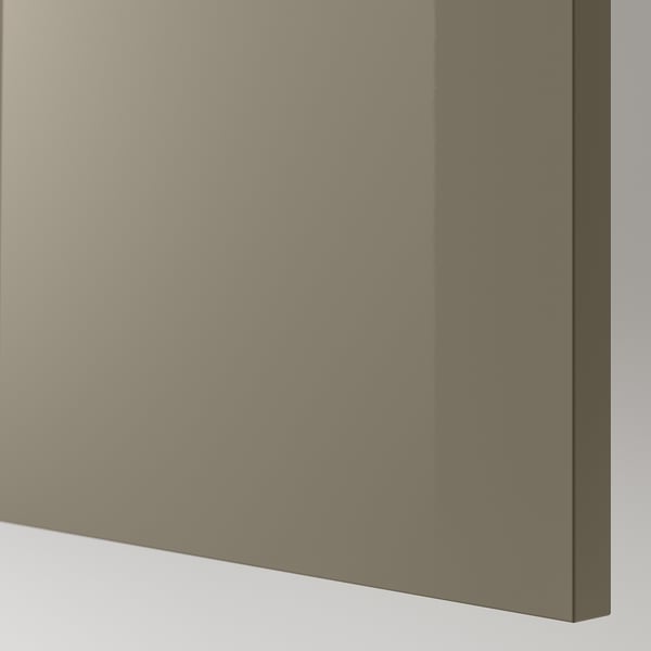 Close-up of high-gloss, smooth, beige panel, likely part of a cabinet or drawer, showing reflective surface and sleek edge.