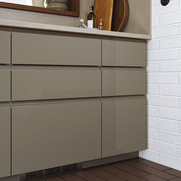 Modern kitchen cabinets with high gloss grey-brown finish and sleek, integrated handles.