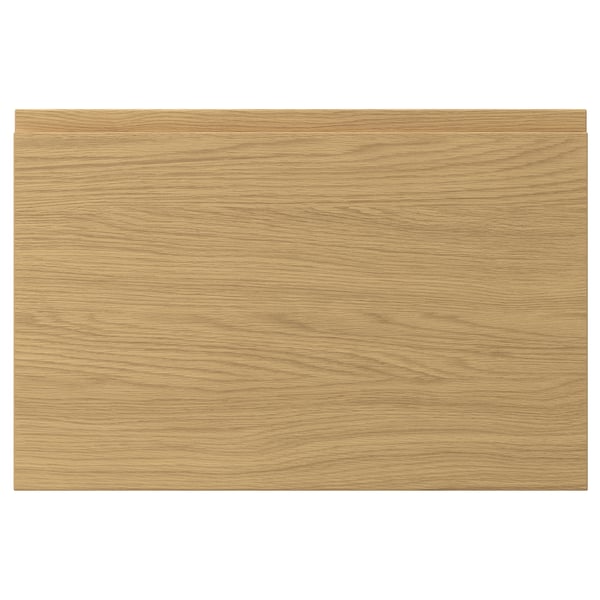 A rectangular oak-finished VOXTORP drawer front with clean lines and integrated handles, featuring a smooth surface and a modern design.