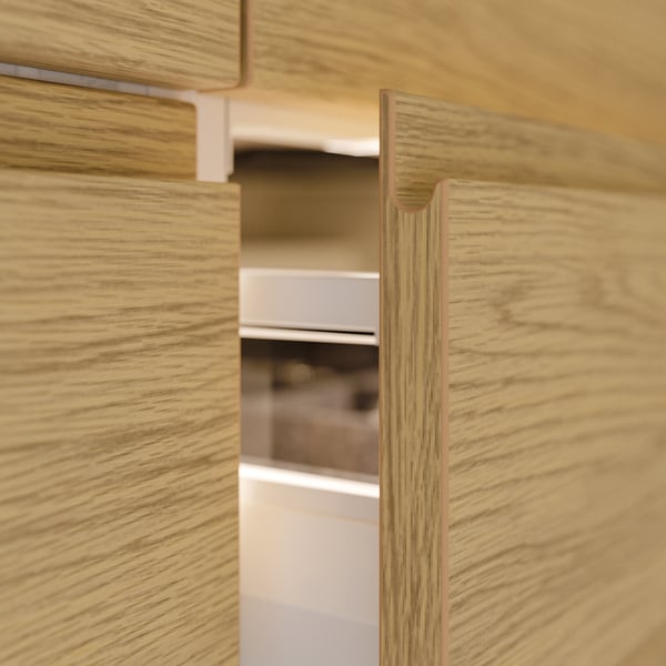 VOXTORP wooden cabinet with oak finish, sleek handles, modern design.