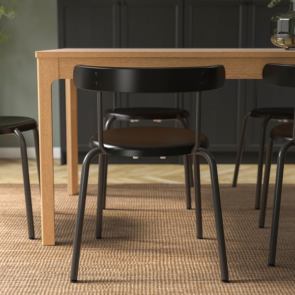 Modern dining chair with rounded back, easy to stack and hang on table, ideal for easy cleaning and efficient space use.