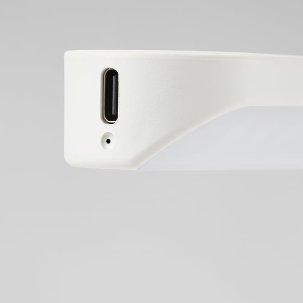 Augšējais skats uz gludu, baltu, modernu LED apgaismojumu ar USB-C portu un nelielu sensora caurumu, kas paredzēts skapjiem vai atvilktnēm.