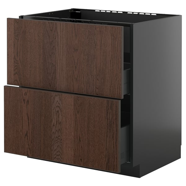 Ikea METOD virtuves bloks ar tumši brūnām sinarp atvilktnēm un melnu rāmi.