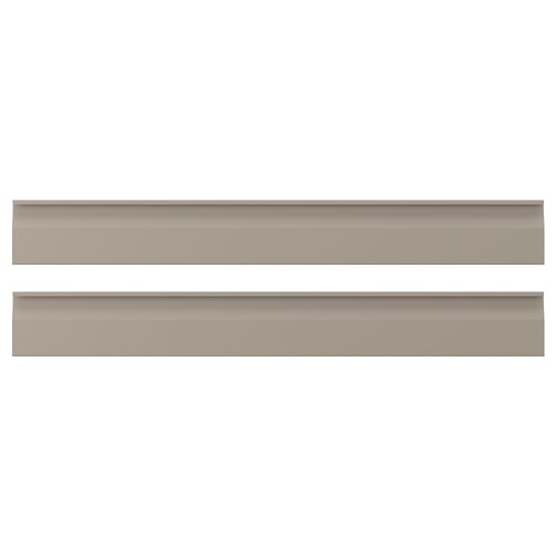 Divi horizontāli, plakani smilškrāsas paneļi ar smalkām, gludām malām un integrētiem rokturiem, kas attēloti uz balta fona.
