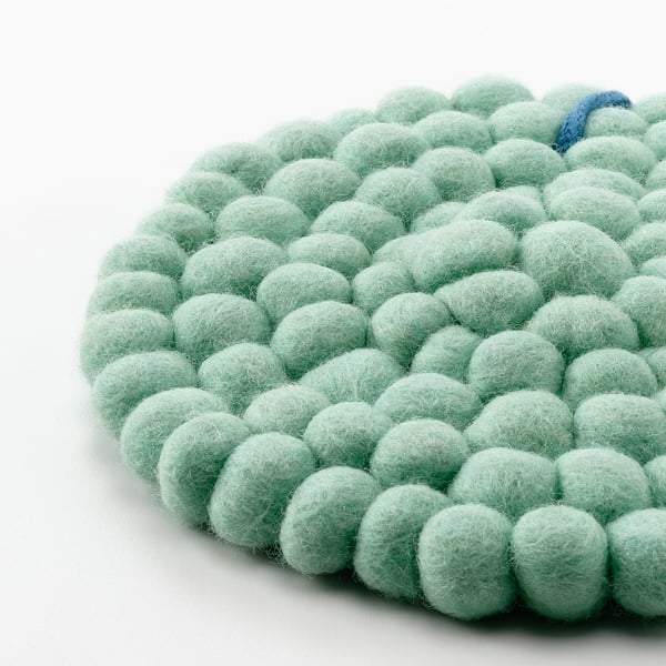 Крупный план текстурированных светло-зеленых трикотажных шерстяных протекторов, демонстрирующих мастерство и качество.