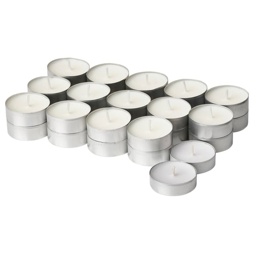 Collection of white ADLAD candles in silver holders, round and stacked in a cluster.