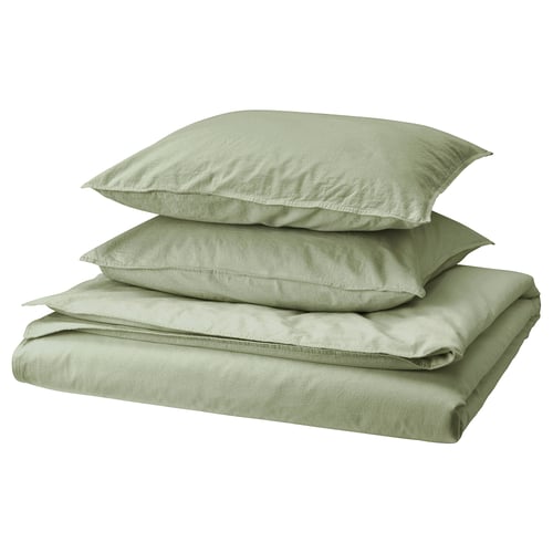 A neatly folded sage green bed linen set, including a duvet cover and pillowcases, made of recycled cotton.