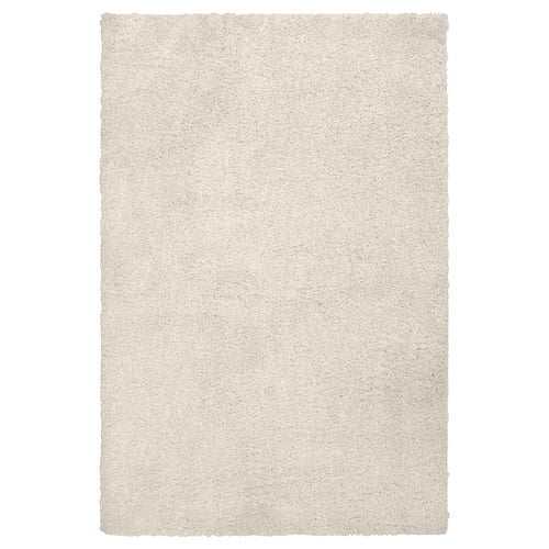 An off-white, rectangular ÄRENDE rug with a thick, soft pile texture, ideal for comfort and sound absorption.