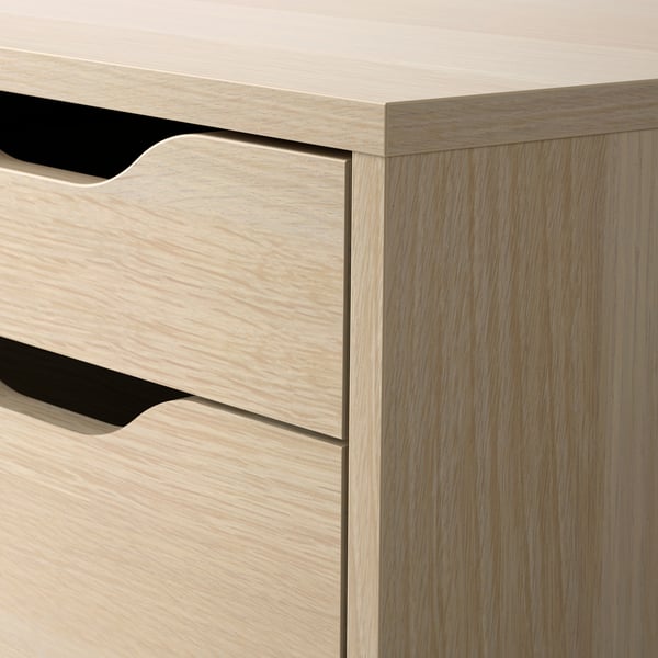 Wooden dresser with multiple drawers and black handles.