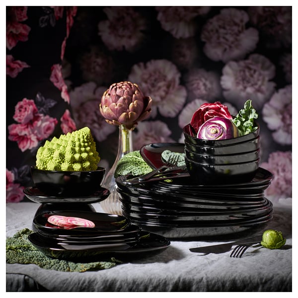 Black glossy BACKIG stoneware-look dinnerware set with dark square plates and bowls, featuring fresh vegetables.