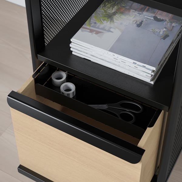 Black BEKANT storage with open drawer revealing scissors and tape, closed shelf with file folders.