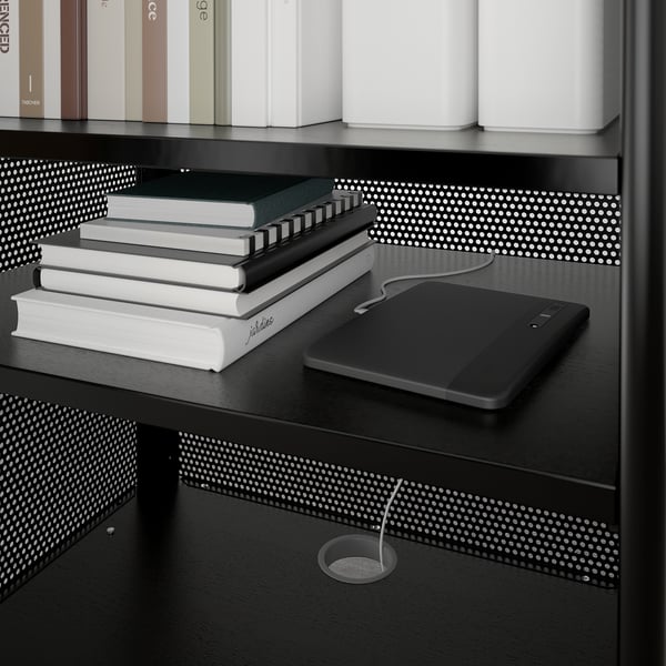 Black BEKANT shelf unit with adjustable shelves holding books and a tablet, featuring a cable management hole.