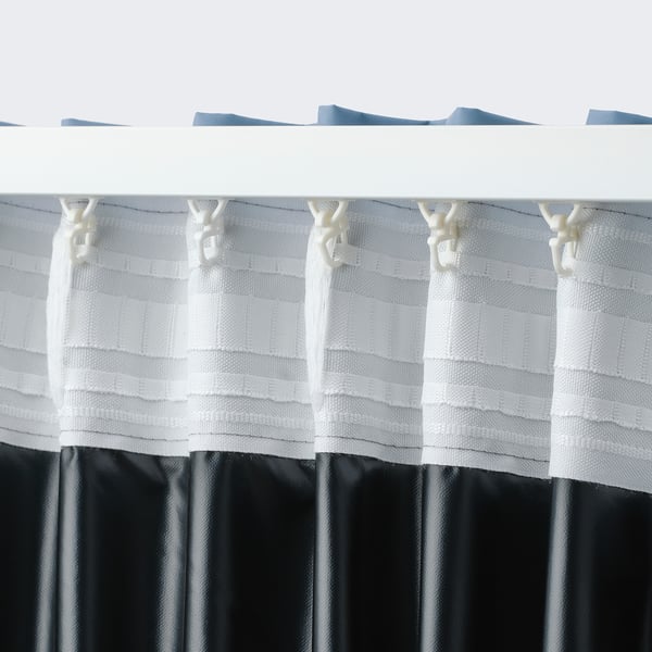White curtain with hooks, designed to block light.