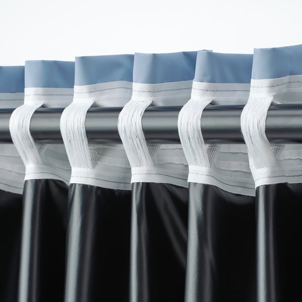 Curtain hooks on wide, blackout BENGTA curtains, ready to hang.