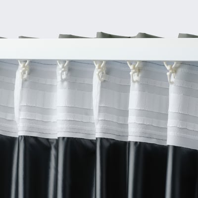 White mesh curtain with hooks, blocks light, hangs wide.