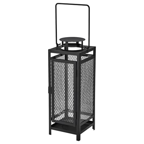 Black metal lantern with mesh design, u-shaped handle, for indoor/outdoor use, holds pillar candle.