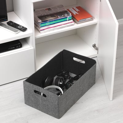 White shelf unit with storage box, containing gaming controllers and headphones. The box is designed for organised storage and easy access.