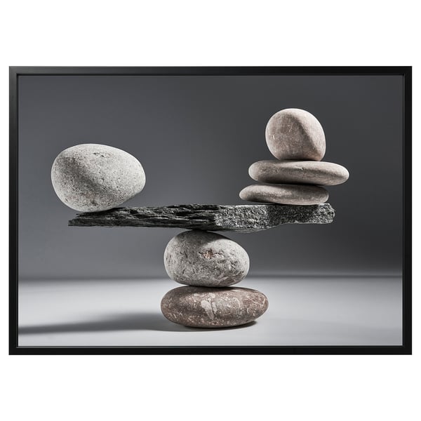 Balanced rock formation photo in black & white, minimalist design.
