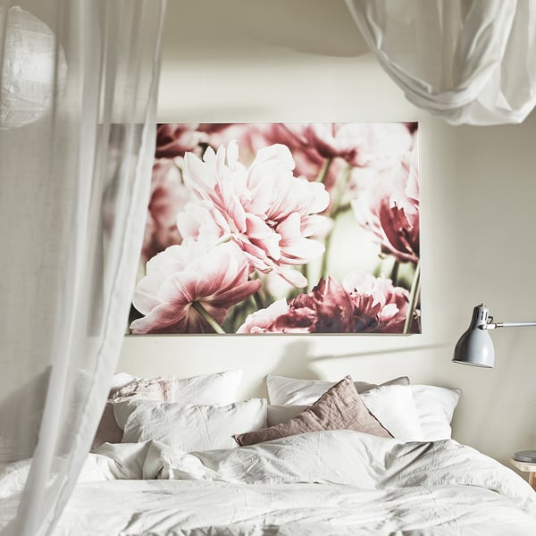 Bedroom with large canvas print of pink flowers above bed with white bedding, frame included.