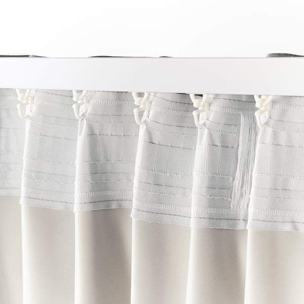 White curtains with tie-backs, featuring textured stripes and tassels, designed for room darkening and privacy.
