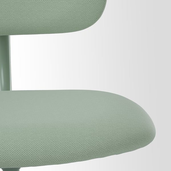 Modern chair close-up: sleek green seat & back, smooth fabric, sturdy frame.