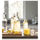 BLODHÄGG Scented candle in glass, lemon & lemongrass/yellow, 40 hr