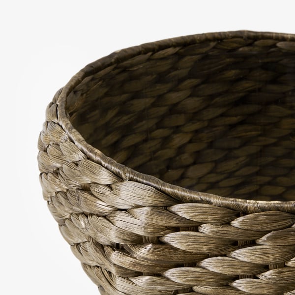 Handwoven water hyacinth basket; intricate, tight-weave; natural, earthy tone; round, broad rim.
