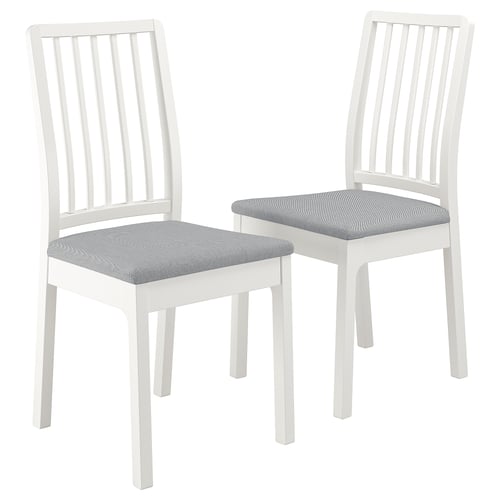 Two white EKEDALEN chairs with grey patterned fabric seats, slatted backs and simple, clean lines.